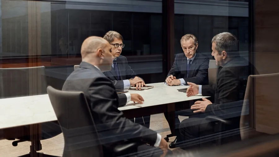 Lenders meeting around a boardroom table